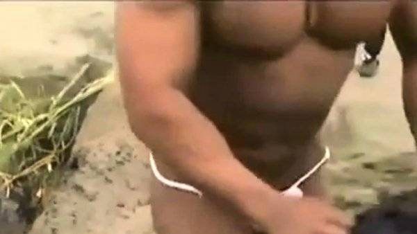 Asian bodybuilder barely covered at the beach on girlsasian.one